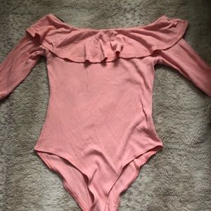 A pink off the shoulder bodysuit